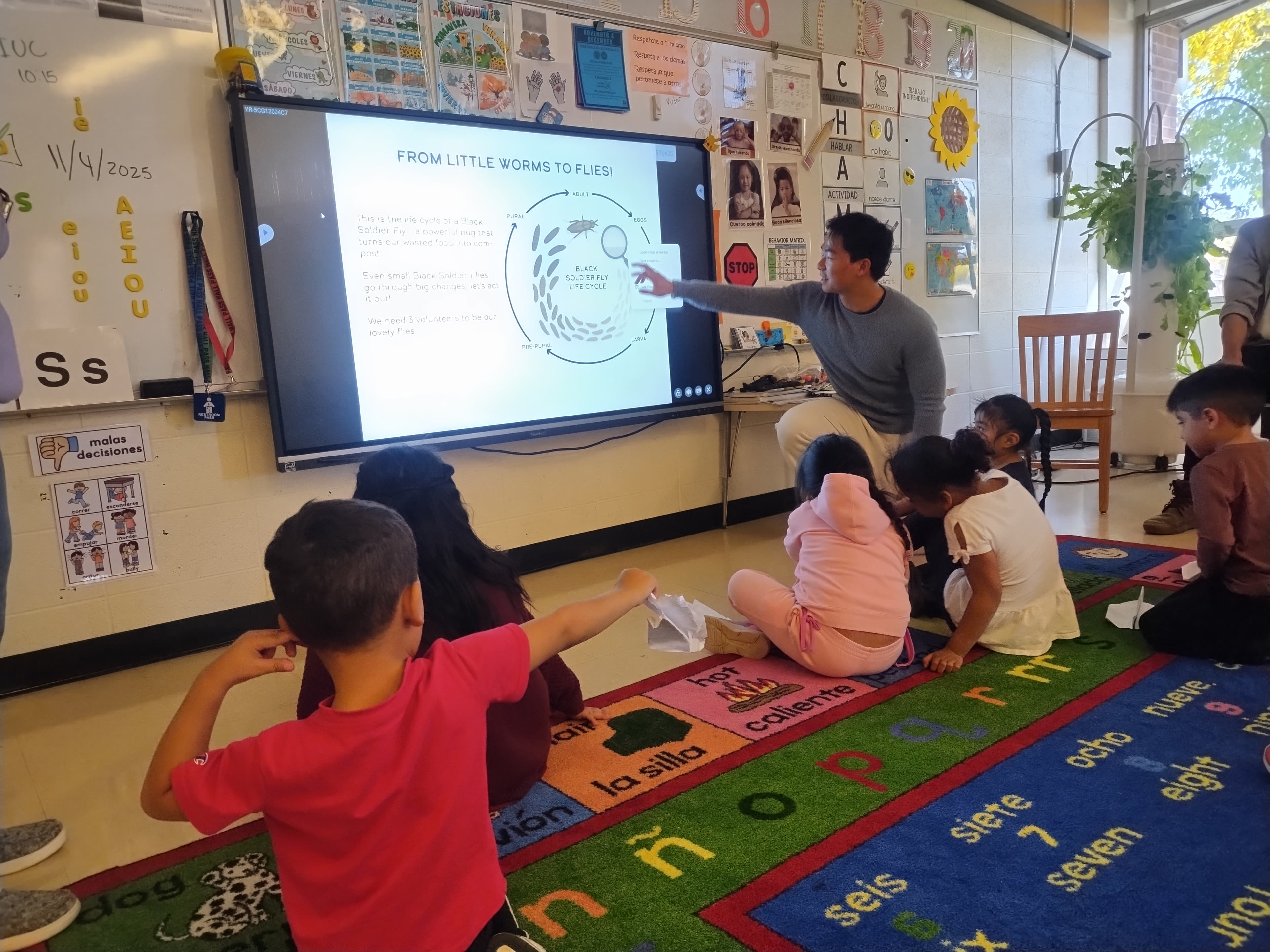 Zuyu teaching students about the BSF composting lifecycle