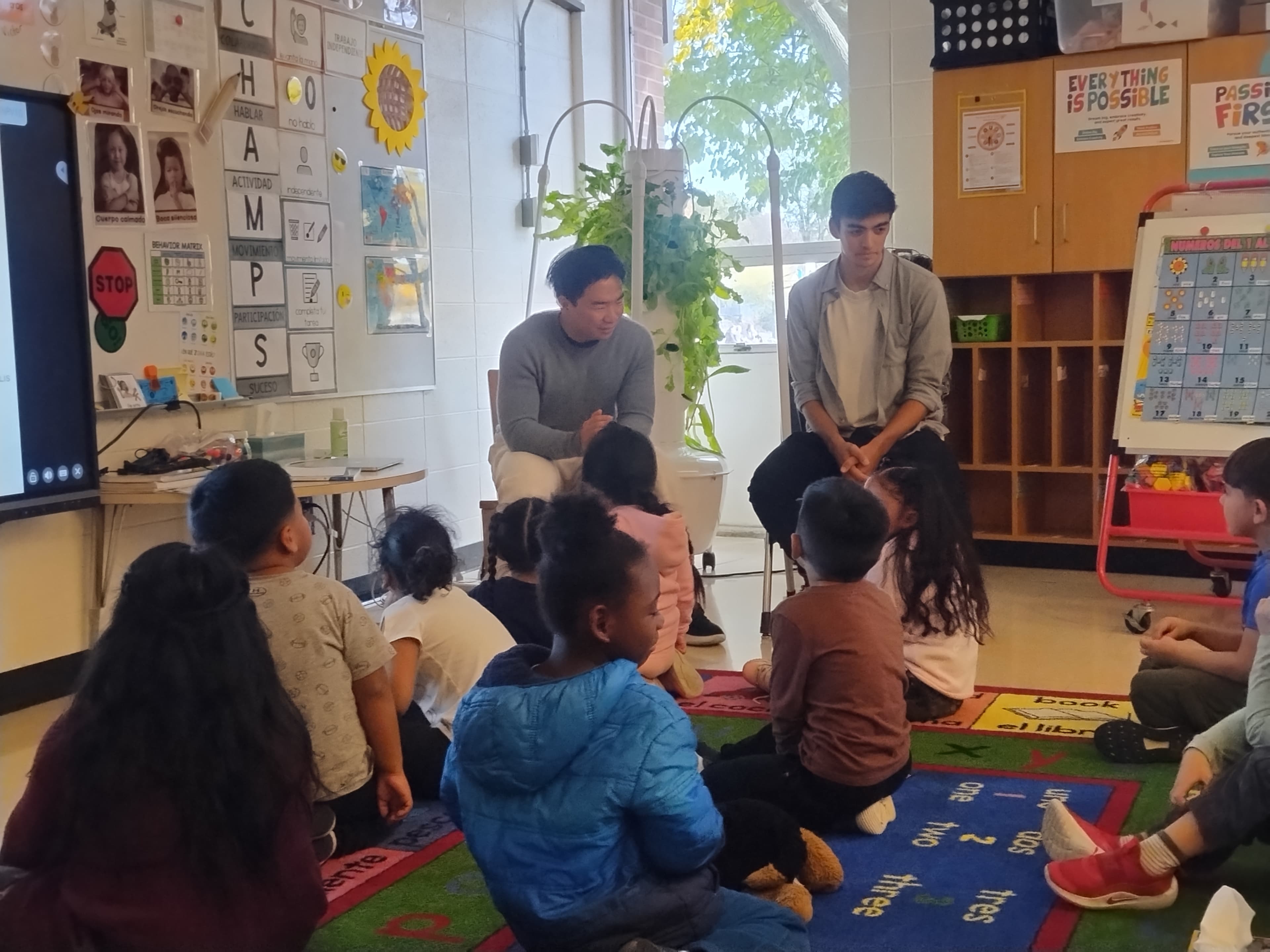 Zuyu and Ethan teaching students on the carpet