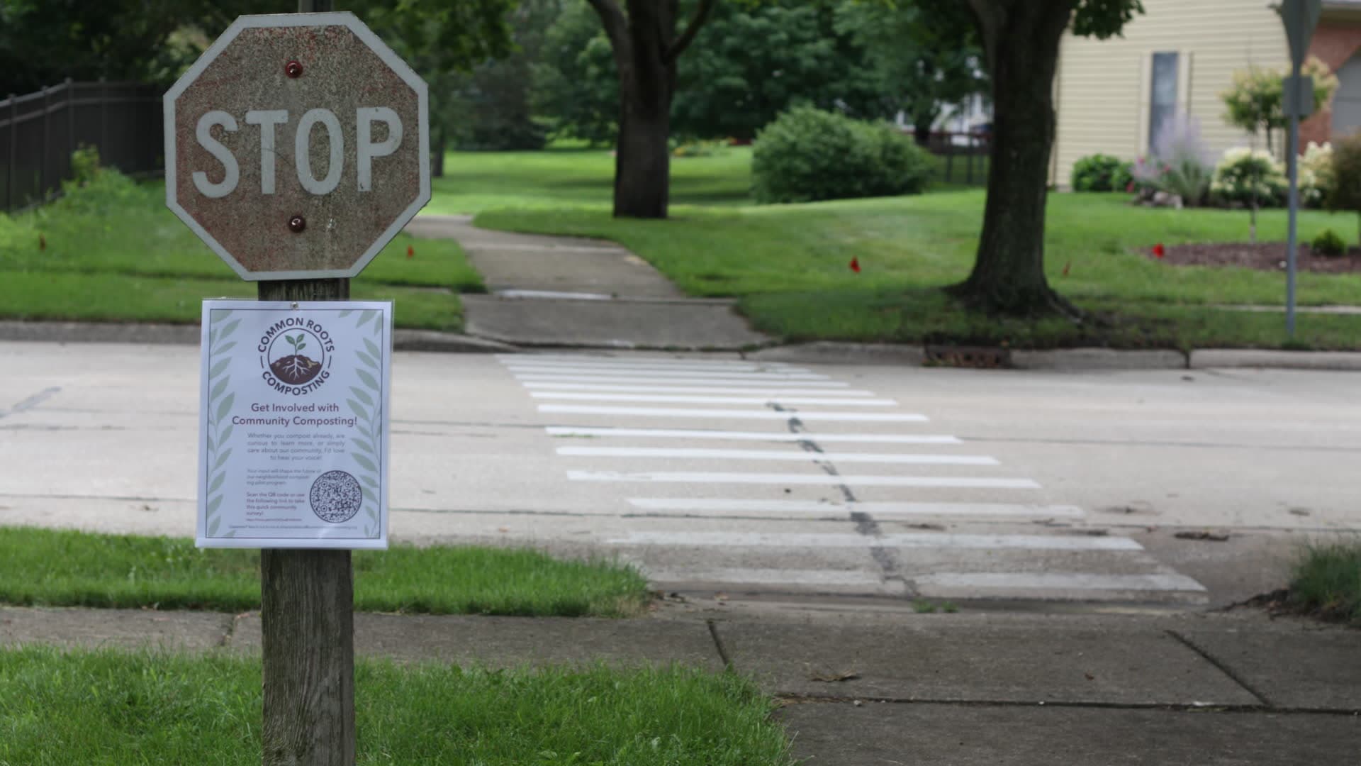 Common Roots Composting flyer posted at a neighborhood stop sign